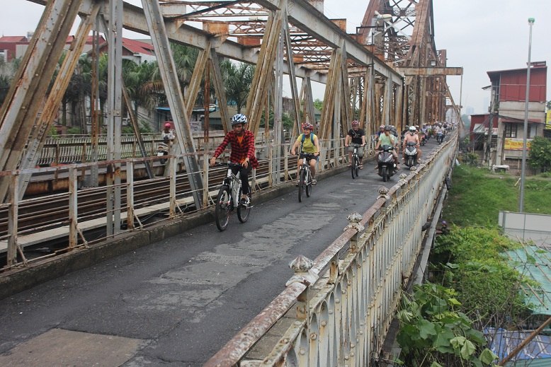 Biking along the bridge Hanoi travel